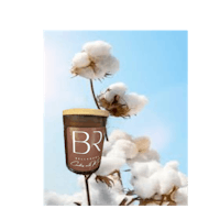 a cup of coffee with a cotton plant in the background